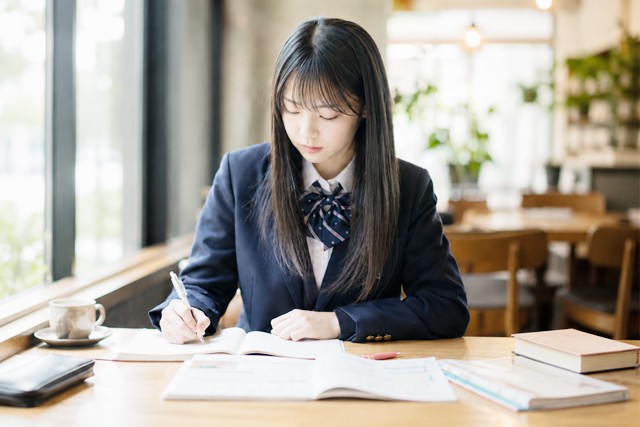 カフェで勉強する女子高校生